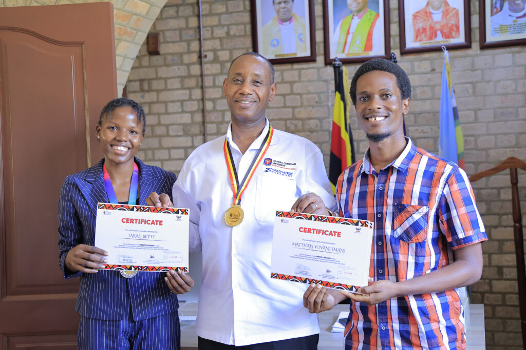 Imani Mathias Yovani and Betty Takali share a light moment with Prof. Aaron Mushengyezi.